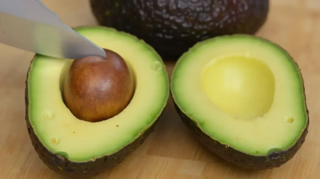 Cutting and preparing an avocado for a salad.